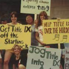 people holding Title IX signs
